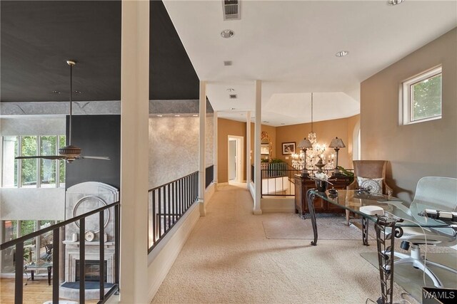 6821 Jade Pt, Tuscaloosa, AL 35406 - hall with plenty of natural light, a chandelier, and carpet flooring