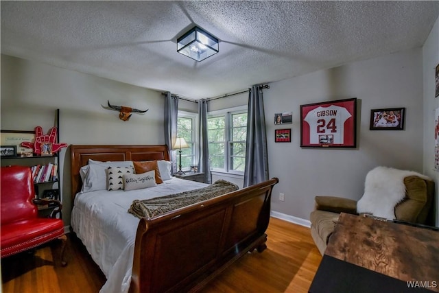 4402 Lakeshore Dr, Northport, AL 35473 - bedroom with wood finished floors and a textured ceiling