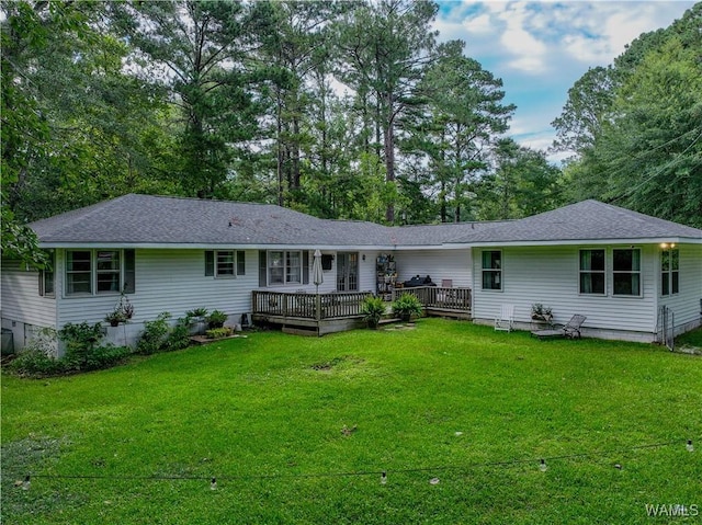 4402 Lakeshore Dr, Northport, AL 35473 - rear view of house featuring a wooden deck, a yard, and roof with shingles