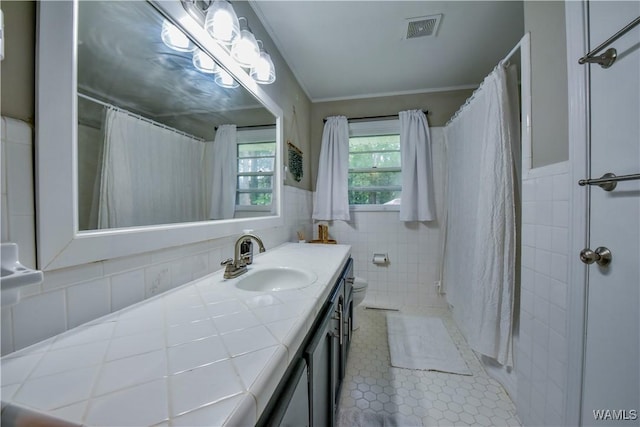 4402 Lakeshore Dr, Northport, AL 35473 - full bathroom with vanity, tile walls, tile patterned floors, a shower with curtain, and a wainscoted wall