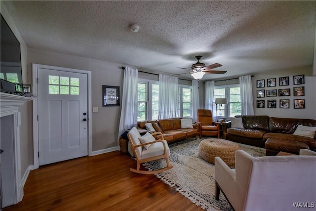 4402 Lakeshore Dr, Northport, AL 35473 - living area featuring a textured ceiling, wood finished floors, and ceiling fan