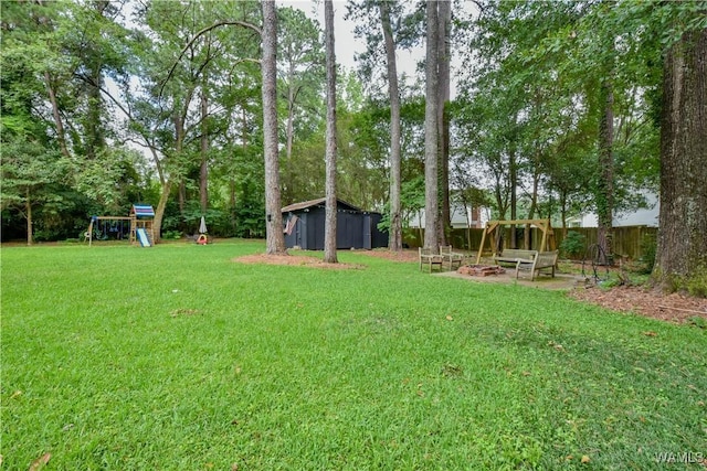 4402 Lakeshore Dr, Northport, AL 35473 - view of yard featuring an outdoor fire pit, a playground, and a shed