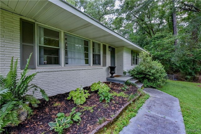 4402 Lakeshore Dr, Northport, AL 35473 - view of exterior entry with brick siding and a yard