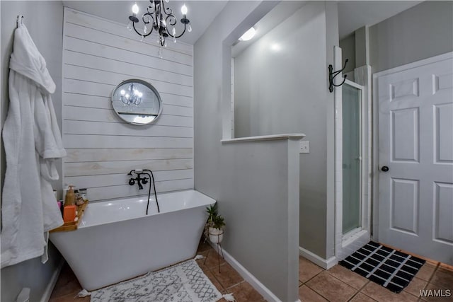 4402 Lakeshore Dr, Northport, AL 35473 - bathroom with a chandelier, tile patterned flooring, a soaking tub, and a stall shower