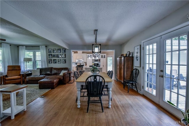 4402 Lakeshore Dr, Northport, AL 35473 - dining room with a textured ceiling, wood finished floors, healthy amount of natural light, and french doors