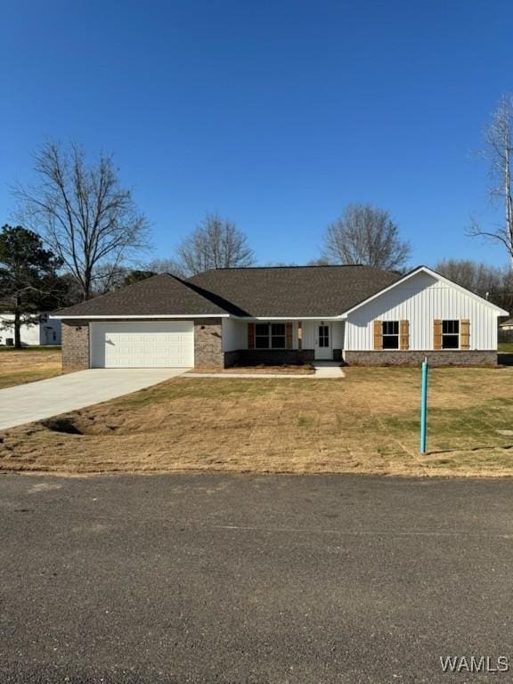 ranch-style house with a front lawn, a garage, and driveway