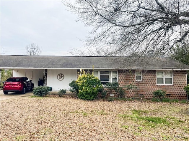 single story home featuring crawl space, driveway, a carport, and brick siding