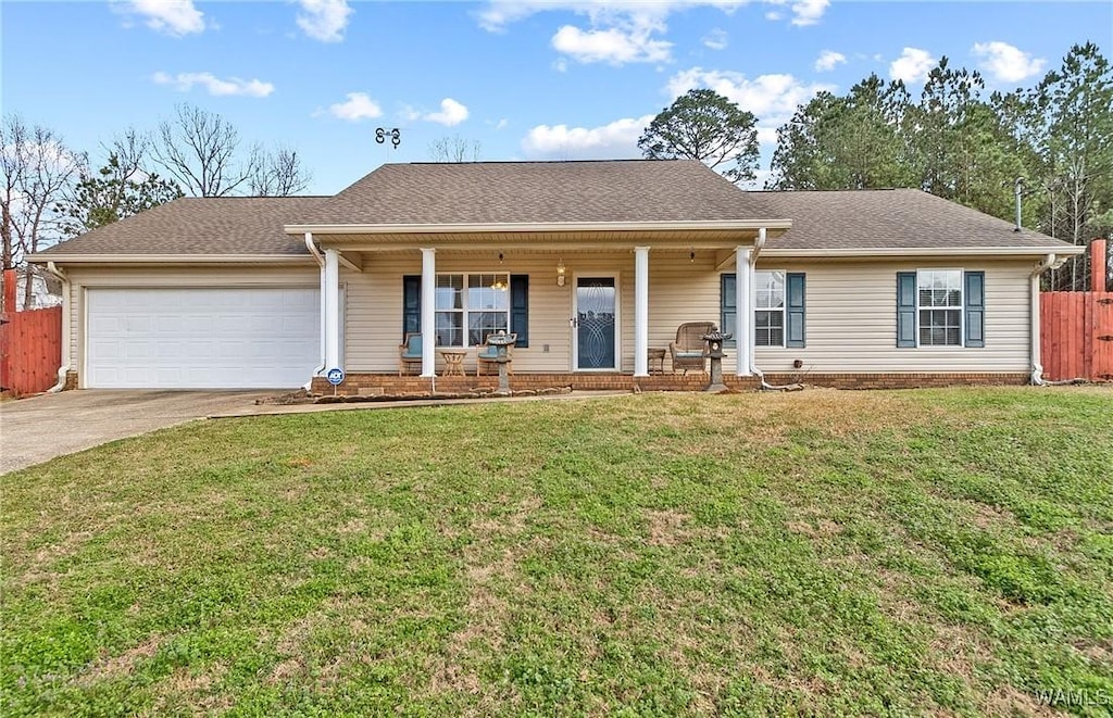 single story home featuring a garage, covered porch, and a front lawn