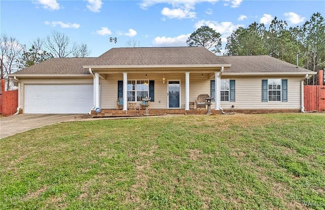 single story home featuring a garage, covered porch, and a front lawn