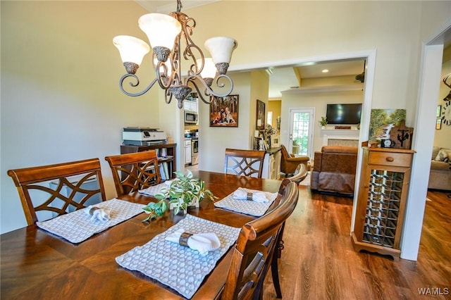 12464 Timberlane Rd, Ralph, AL 35480 - dining area with wood finished floors, a chandelier, crown molding, and a fireplace