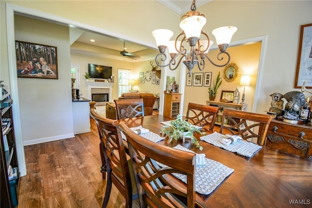 12464 Timberlane Rd, Ralph, AL 35480 - dining space with a fireplace, crown molding, wood finished floors, baseboards, and a chandelier