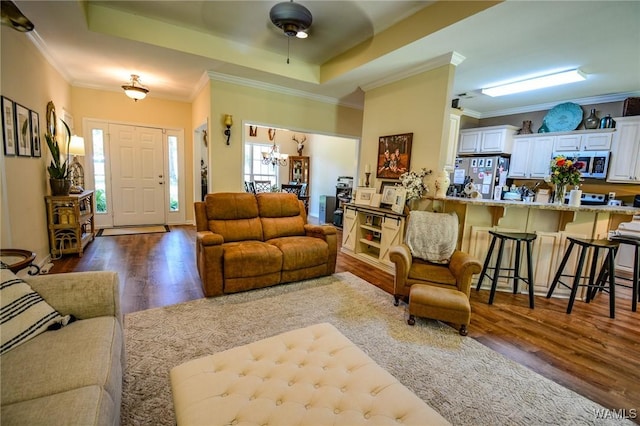 12464 Timberlane Rd, Ralph, AL 35480 - living room featuring dark wood finished floors, a tray ceiling, crown molding, and a ceiling fan