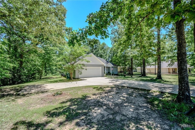 12464 Timberlane Rd, Ralph, AL 35480 - view of side of home featuring driveway, an attached garage, and a lawn
