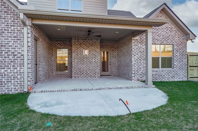 13713 Blackoak Dr, Northport, AL 35475 - entrance to property featuring a patio area, a lawn, a ceiling fan, and brick siding
