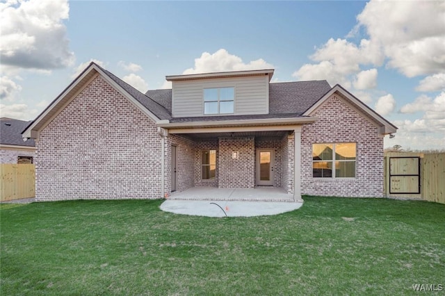 13713 Blackoak Dr, Northport, AL 35475 - rear view of house with brick siding, fence, roof with shingles, a lawn, and a patio area