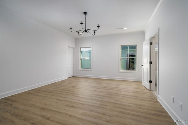 13713 Blackoak Dr, Northport, AL 35475 - empty room featuring baseboards, recessed lighting, wood finished floors, and an inviting chandelier