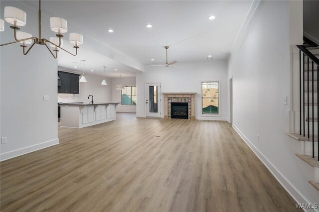 13713 Blackoak Dr, Northport, AL 35475 - unfurnished living room with baseboards, recessed lighting, a fireplace, and light wood-style floors