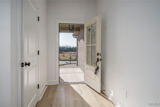 entryway featuring baseboards and wood finished floors