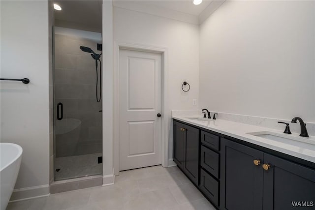 13713 Blackoak Dr, Northport, AL 35475 - bathroom featuring a stall shower, a freestanding tub, a sink, and tile patterned floors