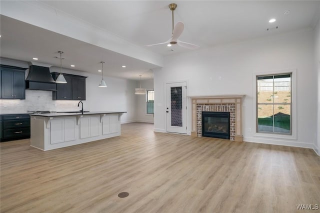 13713 Blackoak Dr, Northport, AL 35475 - kitchen with custom range hood, open floor plan, a wealth of natural light, and a kitchen breakfast bar
