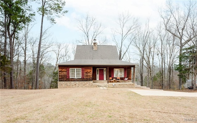 view of front of property featuring a porch, driveway, and a chimney