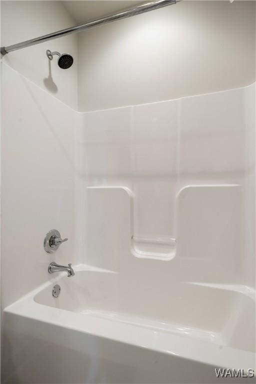 bathroom with shower / washtub combination