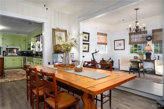 dining room with an inviting chandelier and dark hardwood / wood-style flooring