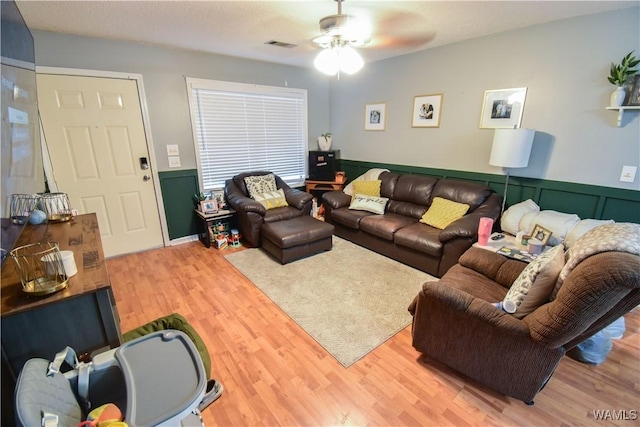 living room featuring ceiling fan and hardwood / wood-style flooring