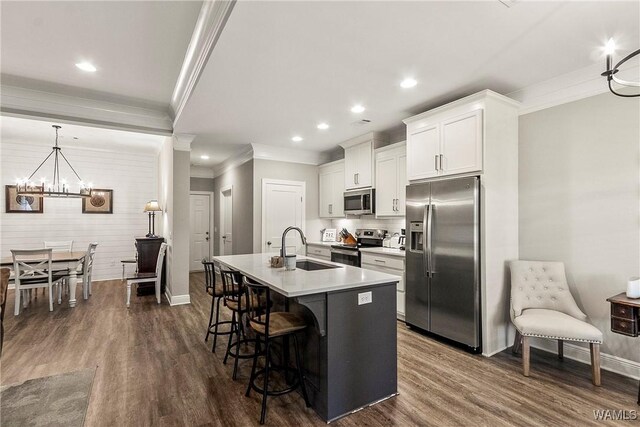 13901 Sullivan Blvd, Northport, AL 35475 - kitchen featuring appliances with stainless steel finishes, ornamental molding, a sink, baseboards, and an island with sink