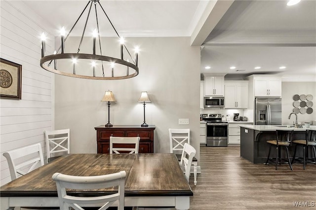 13901 Sullivan Blvd, Northport, AL 35475 - dining space featuring recessed lighting, dark wood-style floors, wooden walls, a chandelier, and crown molding