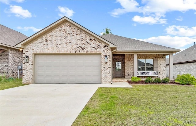 13901 Sullivan Blvd, Northport, AL 35475 - view of front of house featuring an attached garage, brick siding, concrete driveway, a front yard, and covered porch
