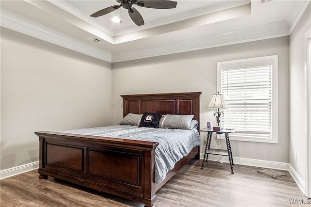 13901 Sullivan Blvd, Northport, AL 35475 - bedroom featuring wood finished floors, a raised ceiling, baseboards, and crown molding