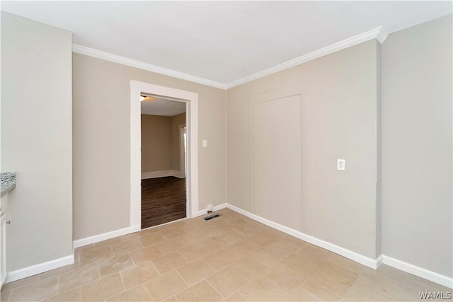 unfurnished room with crown molding