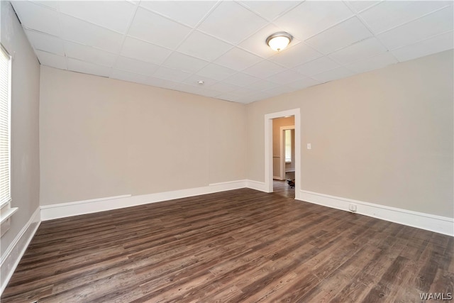 spare room featuring dark wood-type flooring