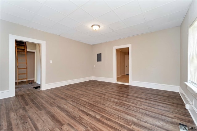 empty room with wood-type flooring and electric panel