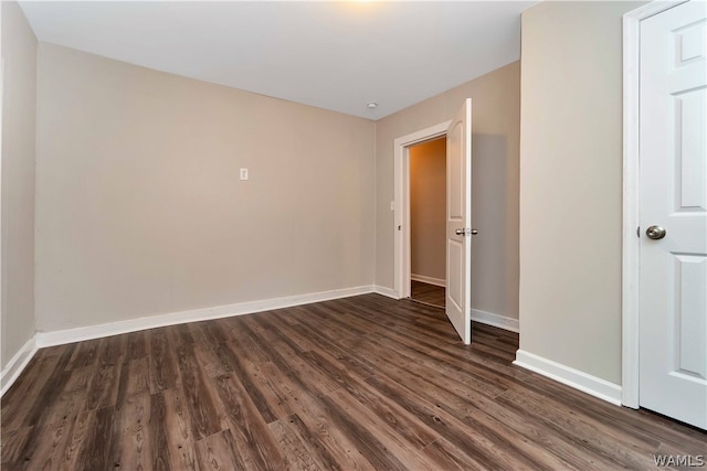 unfurnished room featuring dark wood-type flooring