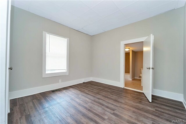 empty room with dark wood-type flooring