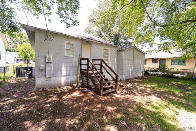 back of house with central AC