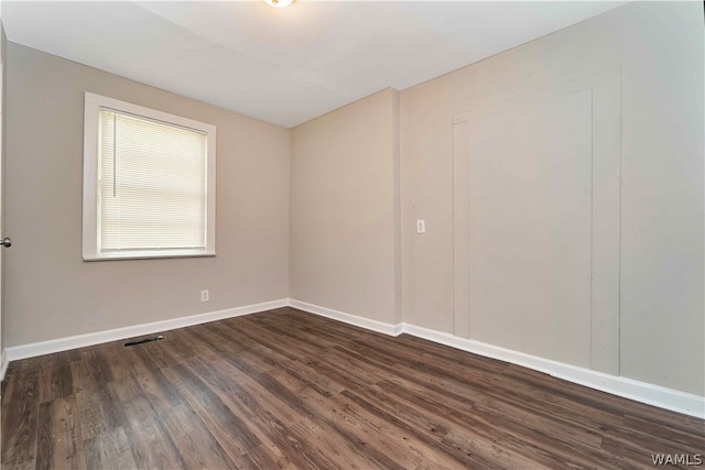 unfurnished room featuring dark hardwood / wood-style flooring