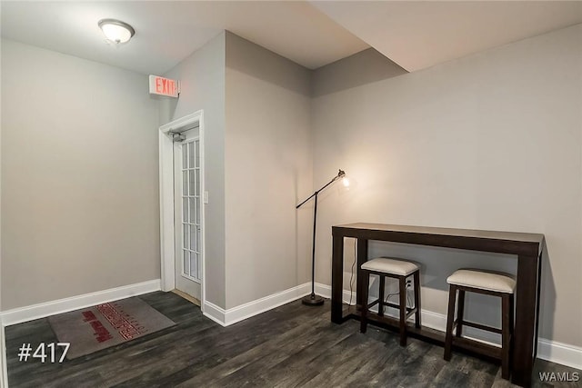 interior space featuring baseboards and wood finished floors