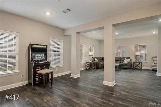 interior space with visible vents, baseboards, and wood finished floors