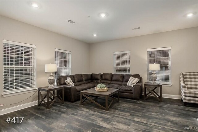 living room with visible vents, recessed lighting, baseboards, and wood finished floors