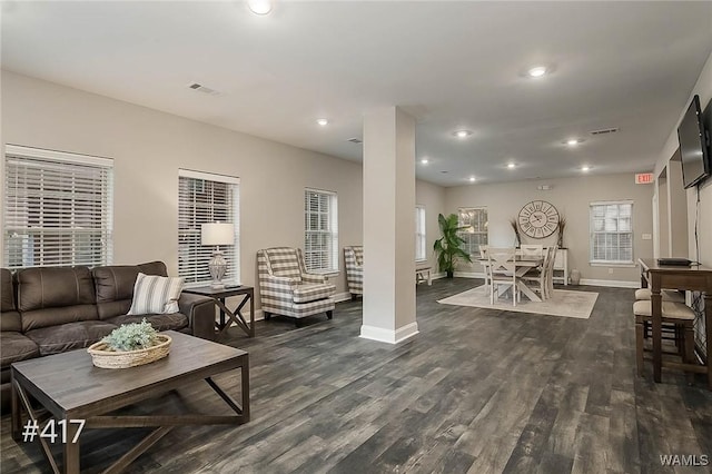 living area with recessed lighting, visible vents, and dark wood-style floors