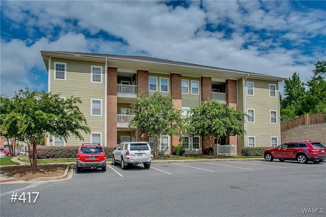 view of building exterior with uncovered parking