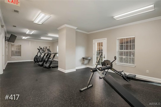 workout area with visible vents, baseboards, and ornamental molding