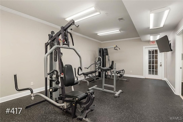 exercise area featuring crown molding, visible vents, and baseboards