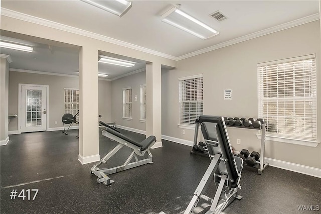 exercise room with visible vents, baseboards, and ornamental molding