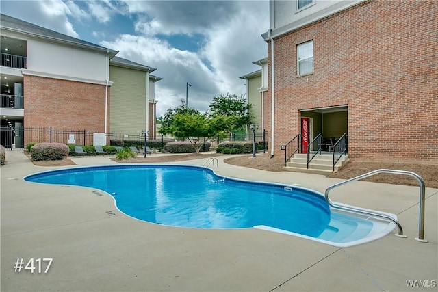 pool featuring a patio area and fence