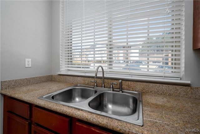 kitchen with a healthy amount of sunlight, light countertops, and a sink