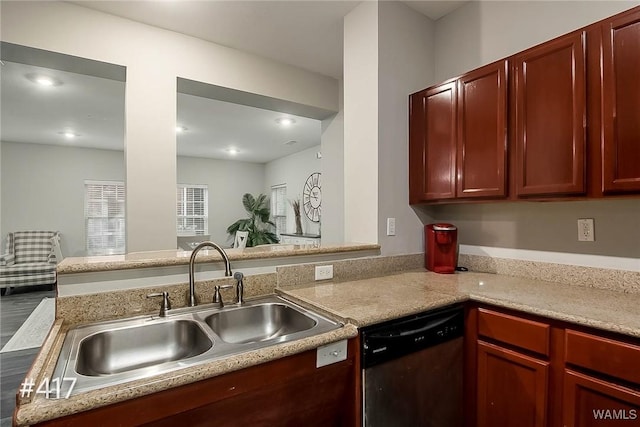 kitchen featuring reddish brown cabinets, light countertops, recessed lighting, stainless steel dishwasher, and a sink